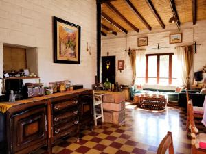 - un salon avec un comptoir et un canapé dans l'établissement La Paleta del Pintor Hosteria, à Maimará