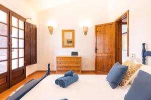 una camera da letto con un letto con cuscini blu di Villa Corallo - FREE WIFI - 1km from the beach a Villasimius