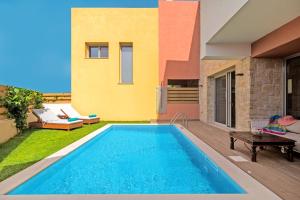 a swimming pool in the backyard of a house at Villa Petra Gouvia by Villa Plus in Gouvia