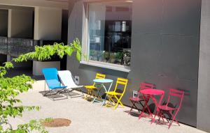 a group of colorful chairs and tables outside a building at Apparteo Strasbourg in Strasbourg +21 photos