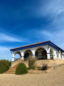 a building with a staircase in front of it at Complejo Rural Mirador de la Alcaidía in Hornachuelos
