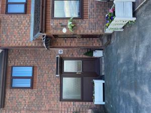 a brick building with a door and plants on it at Beautiful 1-Bed studio in Penrith in Penrith