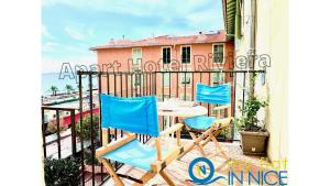 a patio with two chairs and a table on a balcony at ApartHotel Riviera - Nice Côte d'Azur - Old Town - Promenade des Anglais in Nice