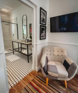 a living room with a chair and a table at 1 Royal Street Guesthouse in Riebeek-Kasteel