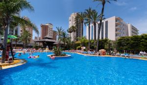a large swimming pool in a resort with people in it at Medplaya Hotel Flamingo Oasis in Benidorm