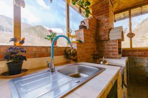 a kitchen with a sink in front of a window at Casa Vio in Nehoiu +75 photos