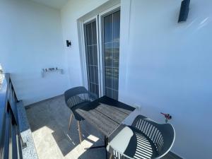 a balcony with two chairs and a table at Villa Denis Ksamil in Ksamil