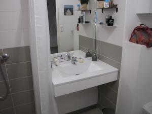 a bathroom with a white sink and a mirror at Bel appartement sur le bassin d'Arcachon, à 2km de la mer in La Teste-de-Buch +8 photos