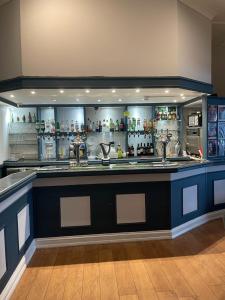 a bar with a blue counter in a room at Metropole Hotel in Torquay