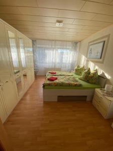a bedroom with a bed with a green comforter at FeWo Taucha in Taucha
