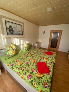 a bedroom with a large bed with a green comforter at FeWo Taucha in Taucha