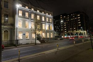 a building on a city street at night at Wilton House Belfast Serviced Apartments in Belfast