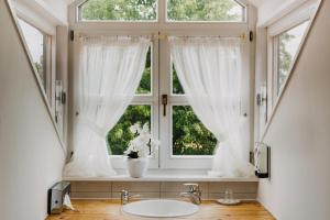 a bathroom with a sink and a window at Gutshof Sagmühle in Bad Griesbach