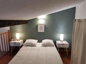 a bedroom with a large bed with two side tables at Le studio de la Comédie, Montpellier, Hyper-centre in Montpellier