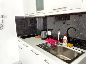 a kitchen with a sink and a counter top at Villa Denis Ksamil in Ksamil