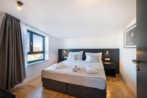 a bedroom with a large bed with two towels on it at Miramare Hotel in Zadar