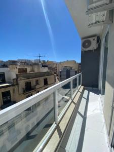 a balcony with a view of a city at Central Modern Apartment Msida in Msida