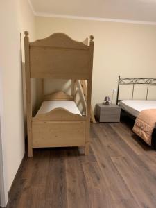 マドンナ・ディ・カンピリオにあるAlberti Casa Maturiのウッドフロアのベッドルーム1室(二段ベッド1組付)
