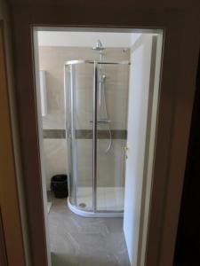 a shower with a glass door in a bathroom at Alberti Casa Maturi in Madonna di Campiglio
