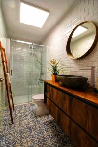 a bathroom with a sink and a toilet and a mirror at Terraço do Castelo in Arraiolos