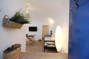 ein Wohnzimmer mit einem Sofa und einem Tisch mit einer Pflanze in der Unterkunft Terraço do Castelo in Arraiolos