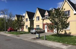 a house with a car parked in front of it at Kerry Lee Homes in Tralee