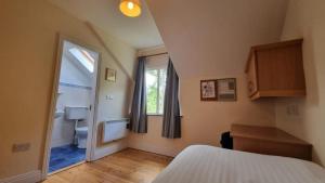 a bedroom with a bed and a window and a toilet at Kerry Lee Homes in Tralee