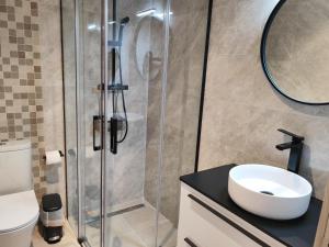 a bathroom with a shower with a sink and a toilet at Hotel Casa Lili in Jávea