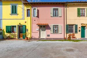 a group of houses with colorful doors and windows at Pisa Airport Comfy Apartment - Private Parking in Pisa