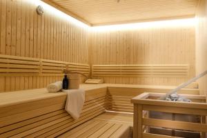 a wooden sauna with a bottle of wine in it at AlpenParks Hotel & Apartment Central Zell am See in Zell am See