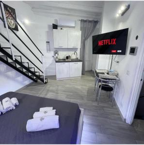een kamer met een Netflix-bord en een keuken bij RC SUITE TERMINI IMERESE in Termini Imerese