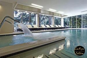 a swimming pool with a fountain in a building at B&B La Rosa Celtica in Capo di Ponte