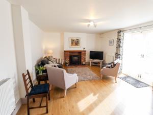 a living room with a couch and a fireplace at Holly Barn in Hull