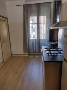 an empty kitchen with a stove and a window at CINQUE TERRE HOUSE OF THE PORT with PARKING in La Spezia