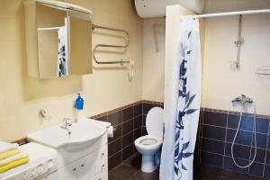 a bathroom with a sink and a toilet at Laisves alley 50 in Kaunas