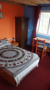 a bedroom with a bed and a table and a window at Namaste Home Stay in Dhulikhel