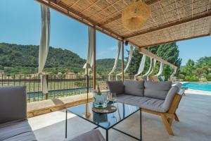 a living room with a couch and a glass table at Rondaia in Esporles