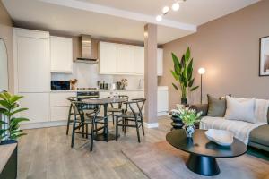 a living room with a couch and a table at Be London - Chinatown Residences in London