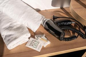 a telephone sitting on a table with a towel at B&B HOTEL Bordeaux Lac sur Bruges in Bruges