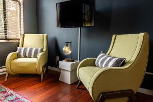 two chairs and a lamp in a living room at Kasa The Oxford Apartments Seattle in Seattle