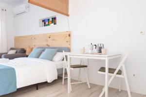 um quarto com uma cama, uma secretária e uma mesa em Estudio Mojito em L'Escala