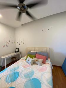 a bedroom with a bed with a ceiling fan at One Residence Sekinchan 适耕庄无敌海景 in Sekincan