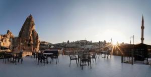a group of tables and chairs on a patio at The Niche Cave Hotel in Goreme