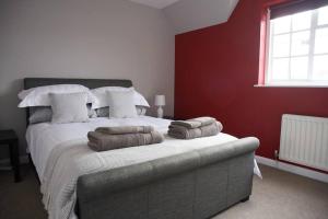 a bedroom with a bed with pillows on it at Garden House in Cirencester