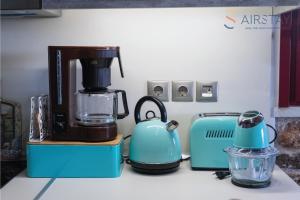 a kitchen counter with a coffee maker and a blender at Orianna Apartment Airport by Airstay in Spáta