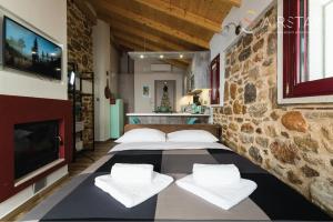 a room with three beds and a tv on a wall at Orianna Apartment Airport by Airstay in Spáta