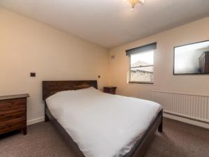 a bedroom with a large bed and a window at Pass the Keys - Cosy Maisonette with Garden in Central East London in London