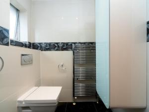 a bathroom with a toilet and a glass shower at Pass the Keys - Cosy Maisonette with Garden in Central East London in London