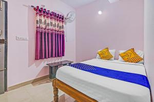 1 dormitorio con cama y ventana en SPOT ON Sln Comforts Near Nagasandra Metro Station, en Bangalore