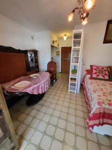 a bedroom with two beds and a table and a chair at Monolocale a Grado in Grado